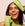Woman holding Curiously Clarifying Conditioner and shampoo against her face focusing on hair freshness